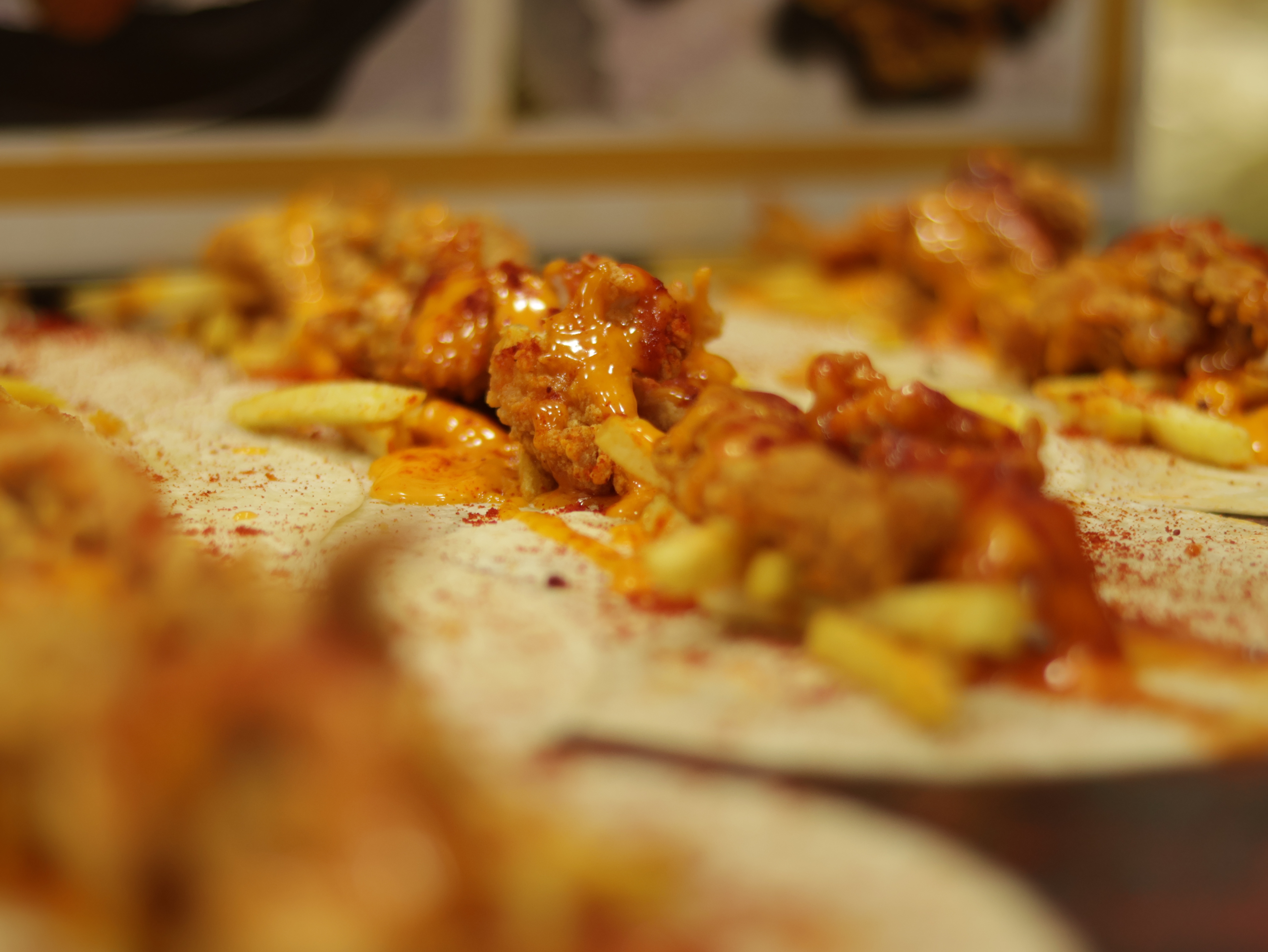 Chef preparing fresh crispy chicken in the open kitchen at Al-Taiba